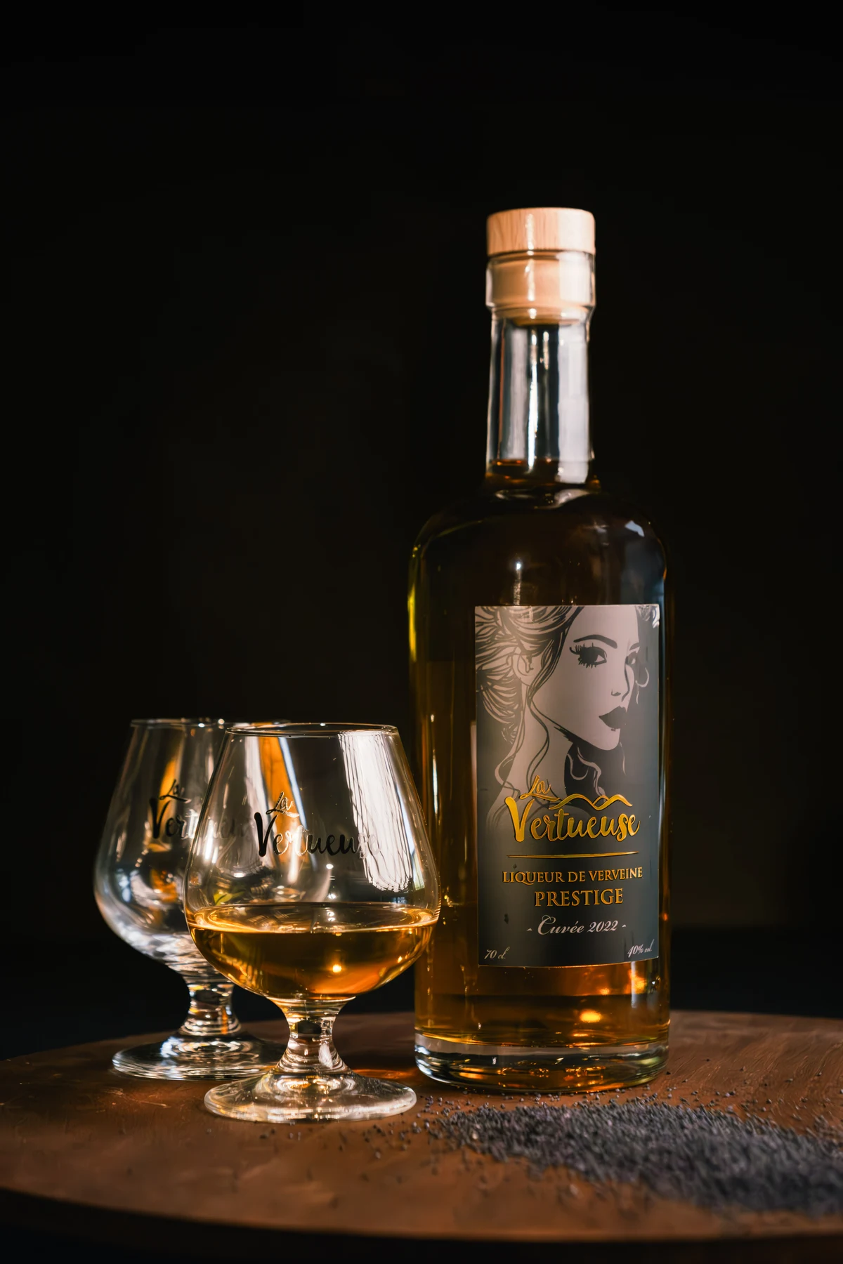 Bouteille de liqueur de verveine La Vertueuse et verres dans une lumière chaude